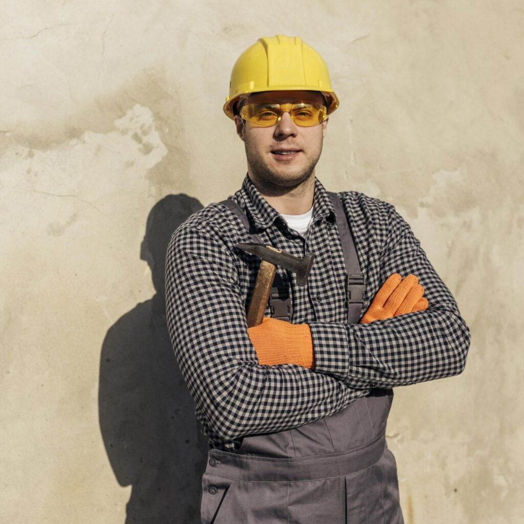 worker with ppe safety glasses, hard hat, and gloves