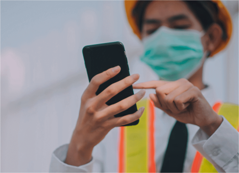 worker with face mask using phone