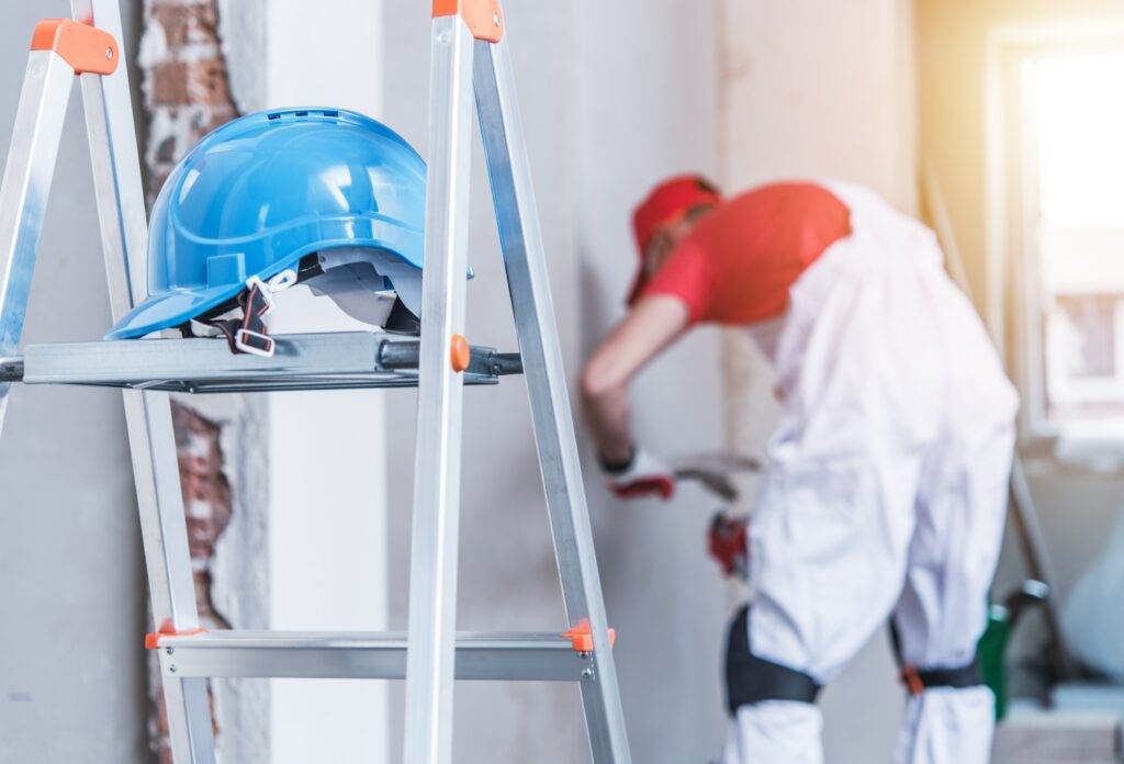 drywall ppe hard hat painting wall