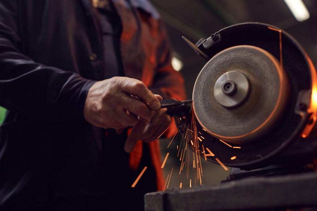 worker using grinder