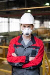 construction worker working safely with lead using respirator