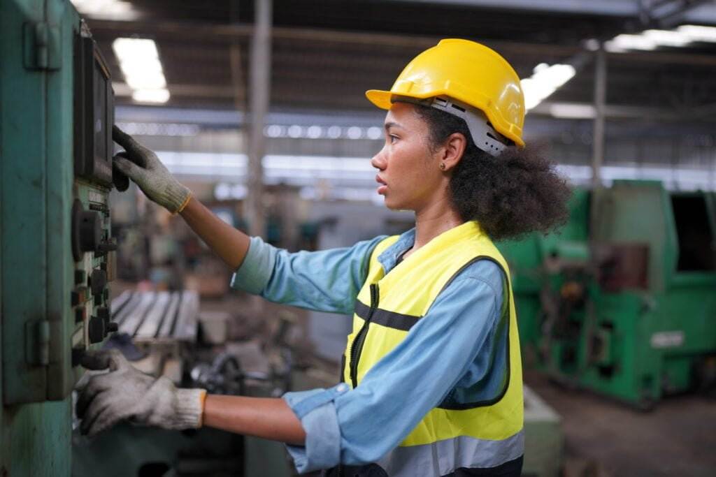 female engineer performing lockout tagout on machine
