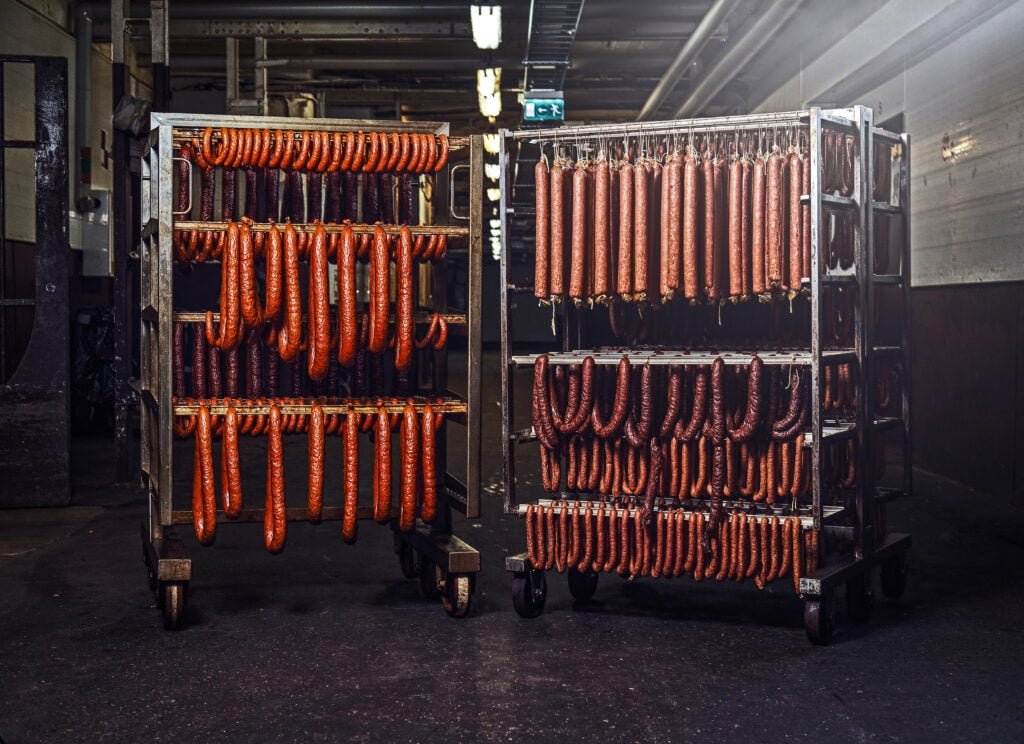 sausages on meat rack in meat processing factory for slaughterhouse employee