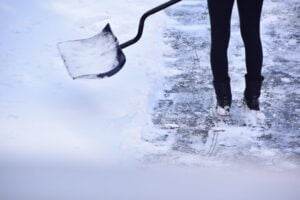 person clearing snow from sideawalk